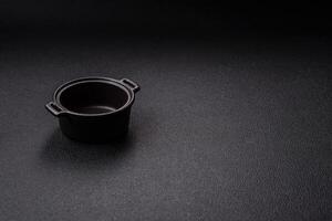 Beautiful empty white ceramic gravy boat on a concrete background photo