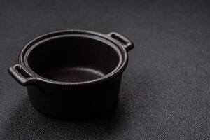 Beautiful empty white ceramic gravy boat on a concrete background photo