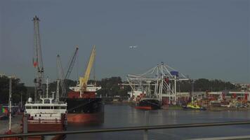 Porto, Portugal. Cargo port with cranes and workers in sunny weather in Oporto. Loading terminal with cargo ships view from the bridge. Global business logistic and transportation. video