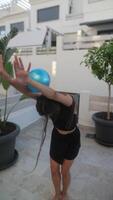 A young woman exuberantly playing with a ball outside in the summer, being active and cheerful video