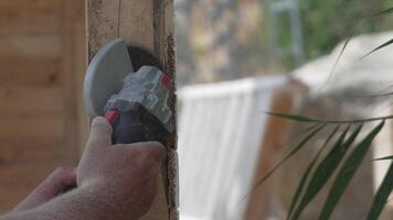 A man is using a power tool to cut wood. Concept of productivity and hard work. Slow motion video