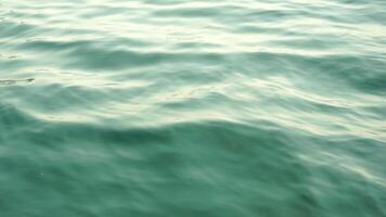 Sea water surface. Low angle view from kayak, camera flies over clear sea water. Nobody. Holiday recreation concept. Abstract nautical summer ocean nature. Slow motion. Close up. Vertical video