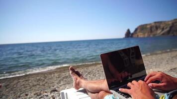Man laptop sea. Working remotely on seashore. Happy successful man, male freelancer working on laptop on beach, relieves stress from work to restore life balance. Freelance, remote work on vacation video