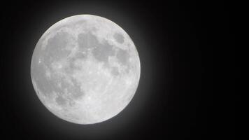 Full moon stars. Glowing yellow huge full moon against starry night sky as seen from earth through clouds. Large full moon moves across the sky, moon makes its way from bottom left frame to top right. video