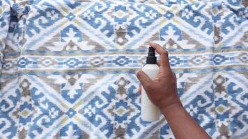 top view of man use spray for clean the bed at home. video