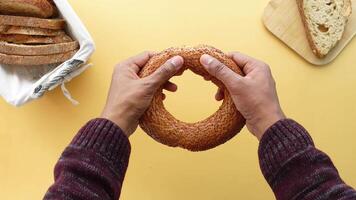 top view of hand cracking a Turkish Bagel Simit video