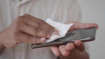 man disinfecting his hands with a wet wipe. video