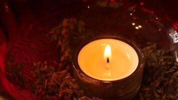 Create a warm and cozy ambiance with candlelight and potpourri in a red glass bowl video