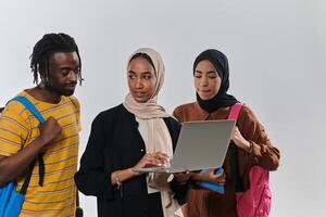 A group of students, including an African American student and two hijab-wearing women, stand united against a pristine white background, symbolizing a harmonious blend of cultures and backgrounds in photo