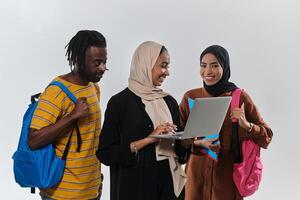 A group of students, including an African American student and two hijab-wearing women, stand united against a pristine white background, symbolizing a harmonious blend of cultures and backgrounds in photo