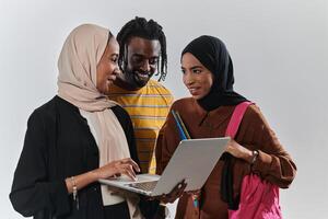 A group of students, including an African American student and two hijab-wearing women, stand united against a pristine white background, symbolizing a harmonious blend of cultures and backgrounds in photo