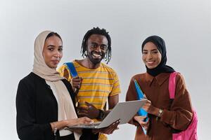 A group of students, including an African American student and two hijab-wearing women, stand united against a pristine white background, symbolizing a harmonious blend of cultures and backgrounds in photo
