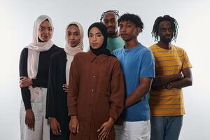 In a vibrant display of educational diversity, a group of students strikes a pose against a clean white background, holding backpacks, laptops, and tablets, symbolizing a blend of modern technology photo