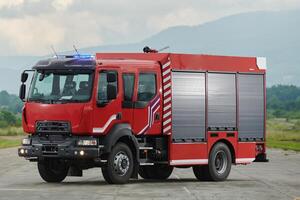 In this captivating scene, a state-of-the-art firetruck, equipped with advanced rescue technology, stands ready with its skilled firefighting team, prepared to intervene and respond rapidly to photo