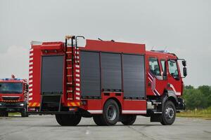 In this captivating scene, a state-of-the-art firetruck, equipped with advanced rescue technology, stands ready with its skilled firefighting team, prepared to intervene and respond rapidly to photo