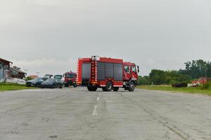 In this captivating scene, a state-of-the-art firetruck, equipped with advanced rescue technology, stands ready with its skilled firefighting team, prepared to intervene and respond rapidly to photo