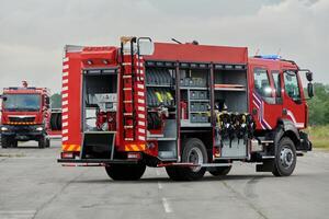 In this captivating scene, a state-of-the-art firetruck, equipped with advanced rescue technology, stands ready with its skilled firefighting team, prepared to intervene and respond rapidly to photo