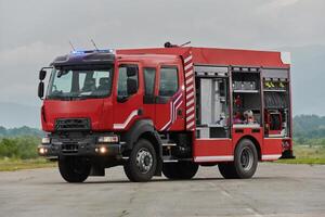 In this captivating scene, a state-of-the-art firetruck, equipped with advanced rescue technology, stands ready with its skilled firefighting team, prepared to intervene and respond rapidly to photo