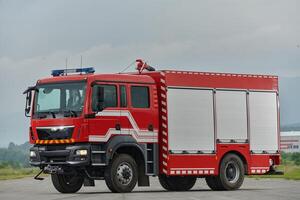 In this captivating scene, a state-of-the-art firetruck, equipped with advanced rescue technology, stands ready with its skilled firefighting team, prepared to intervene and respond rapidly to photo