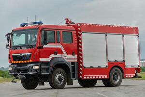 In this captivating scene, a state-of-the-art firetruck, equipped with advanced rescue technology, stands ready with its skilled firefighting team, prepared to intervene and respond rapidly to photo
