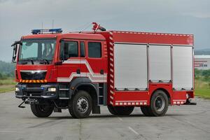 In this captivating scene, a state-of-the-art firetruck, equipped with advanced rescue technology, stands ready with its skilled firefighting team, prepared to intervene and respond rapidly to photo