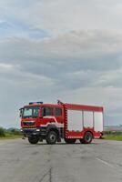 In this captivating scene, a state-of-the-art firetruck, equipped with advanced rescue technology, stands ready with its skilled firefighting team, prepared to intervene and respond rapidly to photo