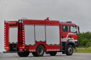 In this captivating scene, a state-of-the-art firetruck, equipped with advanced rescue technology, stands ready with its skilled firefighting team, prepared to intervene and respond rapidly to photo