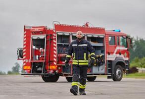 A symbolically brave firefighter strides forward with unwavering courage, epitomizing dedication and leadership, while behind him, a modern firetruck stands ready for firefighting actions, capturing photo