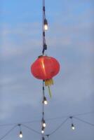 a red lantern hanging from a string photo