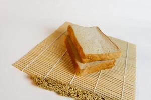 studio photography of bread and wheat on an isolated white background photo
