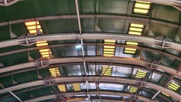 the ceiling of a building with many lights photo