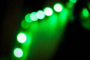 Defocused abstract background of green light in the night photo