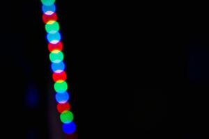 Defocused abstract background of red, blue, and green light in the night photo