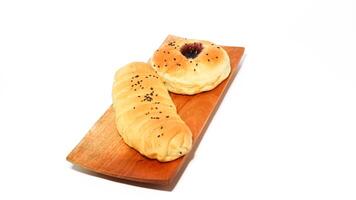 Indonesian bread filled with strawberries and chocolate banana bread isolated on white background. Selective focus photo