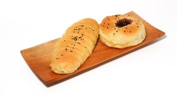 Indonesian bread filled with strawberries and chocolate banana bread isolated on white background. Selective focus photo