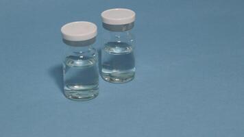 Container with tweezers, holder and contact lenses on a blue background photo
