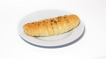 Traditional Indonesian snack called - chocolate banana bread, which is bread filled with banana and chocolate jam served on a plate isolated on a white background photo