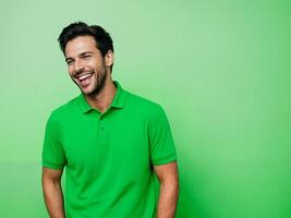 Confident man laughing while standing against green background photo