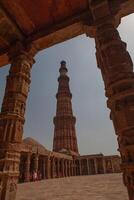 The ancient tower is made of red bricks. Taking photos under the walkway roof
