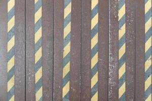 Background and texturd above view of SHERA artificial wood panels. with Yellow and black anti-slip strips to prevent accidents. Backgund is install use in the walkway. photo