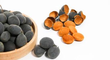 Kranji Tamarind Fruit, Dialium indum, the tamarind-plum, is a tall, tropical, fruit-bearing tree. It belongs to the family Fabaceae, and has small, typically grape-sized edible fruits. photo