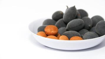 Kranji Tamarind Fruit, Dialium indum, the tamarind-plum, is a tall, tropical, fruit-bearing tree. It belongs to the family Fabaceae, and has small, typically grape-sized edible fruits. photo