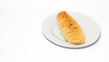 Traditional Indonesian snack called, chocolate banana bread which is bread filled with banana and chocolate jam served on a plate isolated on a white background photo