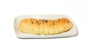 Traditional Indonesian snack called, chocolate banana bread which is bread filled with banana and chocolate jam served on a plate isolated on a white background photo