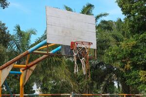View of an old basketball hoop in the sky from a low angle photo