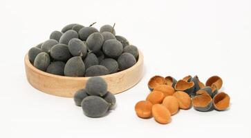 Kranji Tamarind Fruit, Dialium indum, the tamarind-plum, is a tall, tropical, fruit-bearing tree. It belongs to the family Fabaceae, and has small, typically grape-sized edible fruits. photo