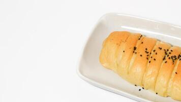 Traditional Indonesian snack called, chocolate banana bread which is bread filled with banana and chocolate jam served on a plate isolated on a white background photo