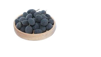 Kranji Tamarind Fruit, Dialium indum, the tamarind-plum, is a tall, tropical, fruit-bearing tree. It belongs to the family Fabaceae, and has small, typically grape-sized edible fruits. photo
