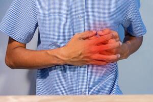 Man pressing on chest or suffering from chest pain. Heart attack symptom. photo