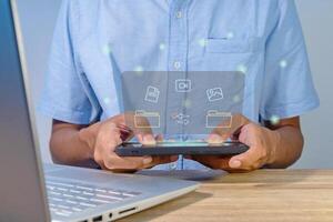 File transfer between mobile phone and laptop. Copy file and media or exchange data on virtual screen. photo